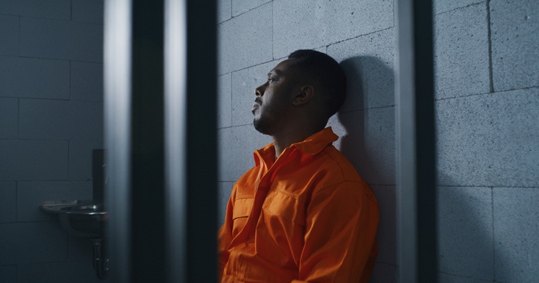 man in prison cell