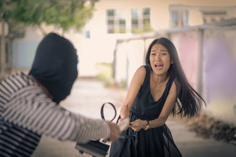 Man with knife robbing a woman